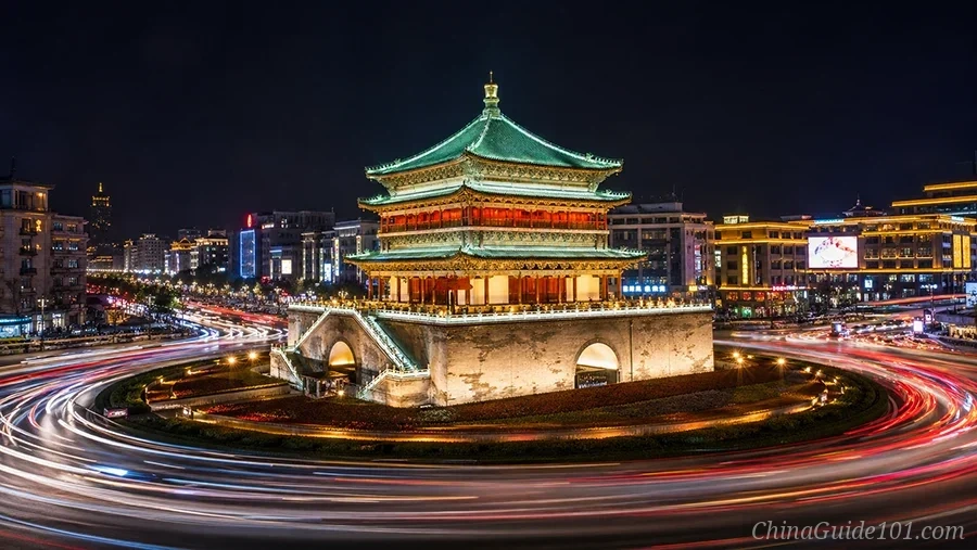 Long exposure of the ancient Xi'an Bell Tower at night with modern car light trails, Ming Dynasty architecture in China
