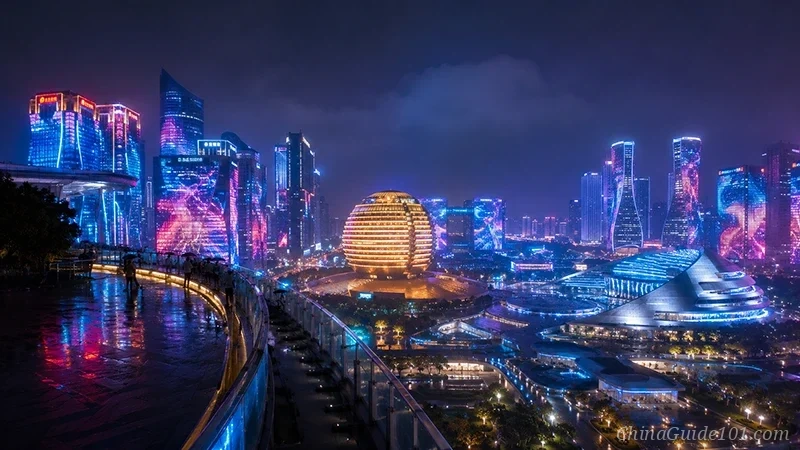 A futuristic night scene of Qianjiang New Town, Hangzhou, as viewed from the City Balcony. Skyscrapers are draped in a dynamic, dynamic, colorful LED light show, with the distinct Golden Ball and Silver Moon buildings glowing intensely against the neon city skyline.