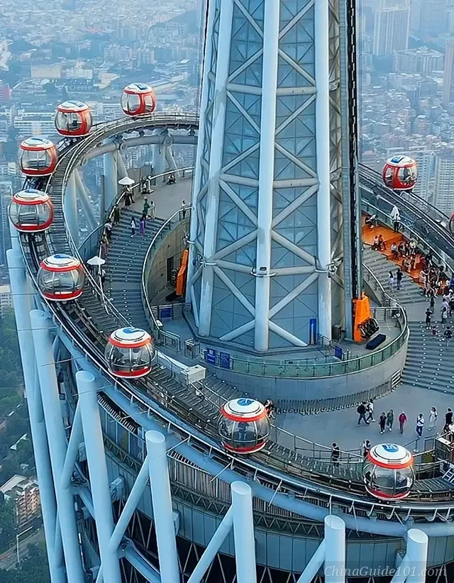 A top-down detailed view of the Canton Tower Bubble Tram at 450 meters. Transparent spherical cabins orbit the tower's tilted track, offering passengers 360-degree views of the city below