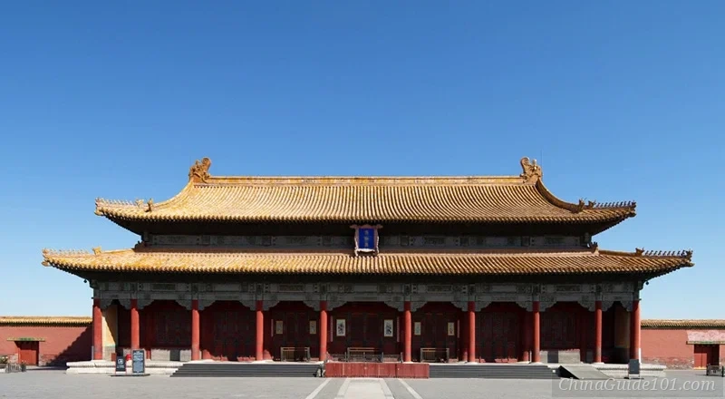 A straight-on architectural shot of the Hall of Preserved Harmony at the Palace Museum, Beijing, highlighting its golden tiled roof and iconic red pillars under a solid blue sky