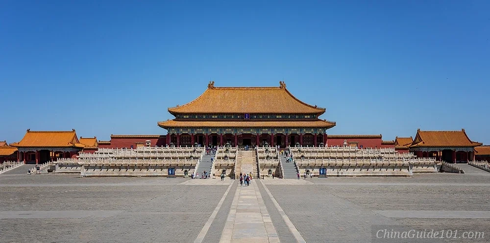 The Hall of Supreme Harmony in Beijing's Palace Museum, showcasing traditional Chinese imperial architecture with its iconic yellow tiled roof and white marble terraces under a bright blue sky