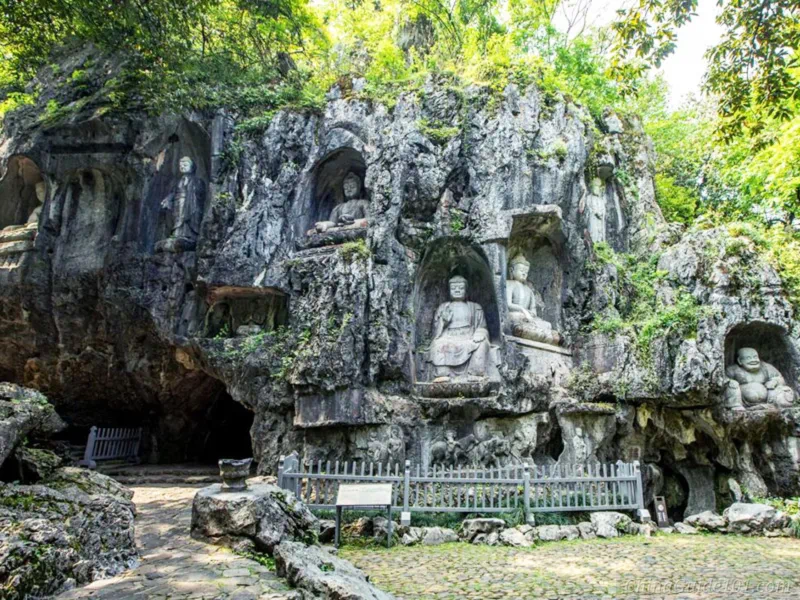 Ancient stone Buddhist statues and carvings embedded in the rocky cliffside at Feilai Peak near Lingyin Temple, Hangzhou