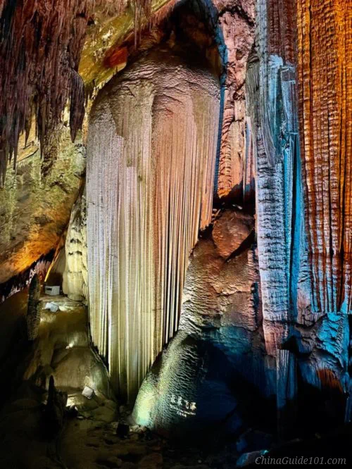 Illuminated limestone stalactite and flowstone formations inside Furong Cave, part of the Wulong Karst UNESCO site near Chongqing, China