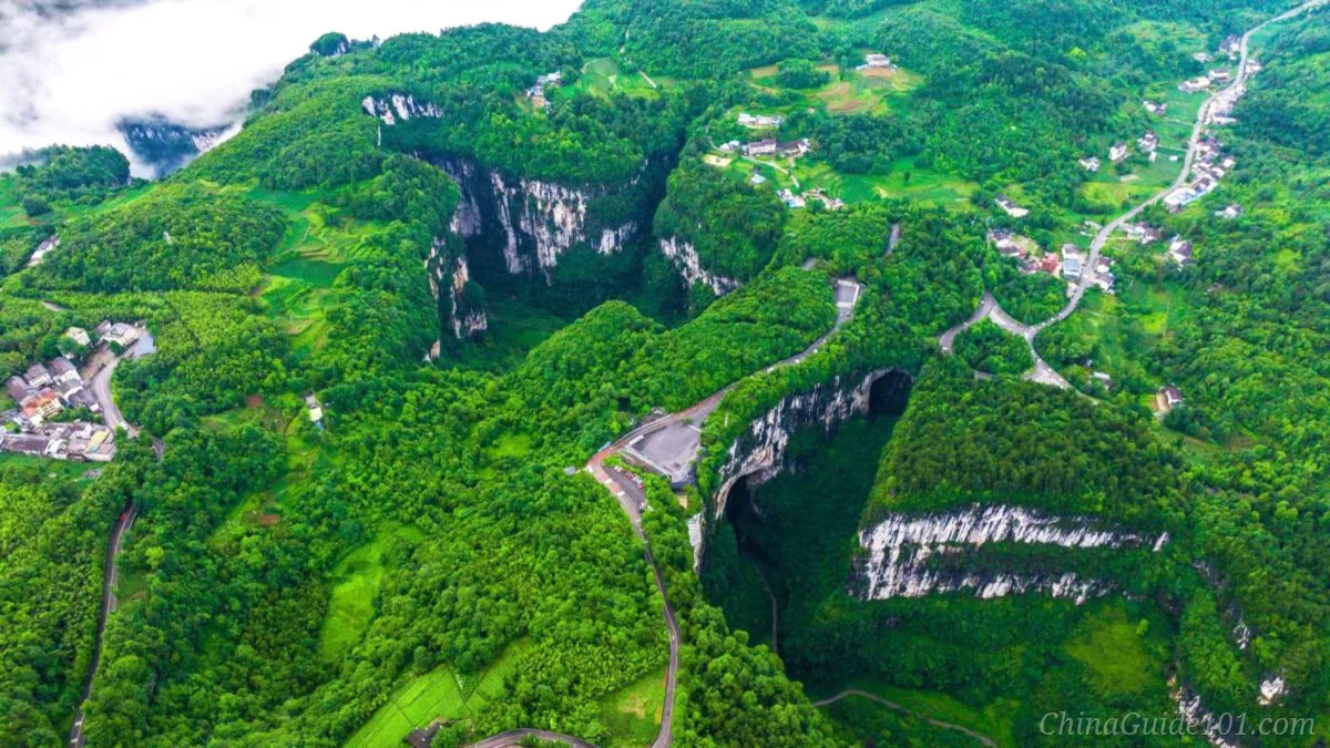 Aerial view of Three Natural Bridges sinkholes and limestone arches at Wulong Karst, UNESCO South China Karst site near Chongqing, China