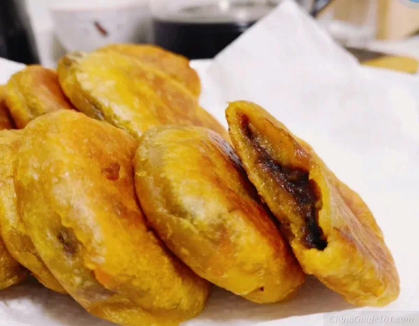 xian persimmon cakes (shizi bing), golden fried pastries filled with sweet red bean paste, classic shaanxi street food