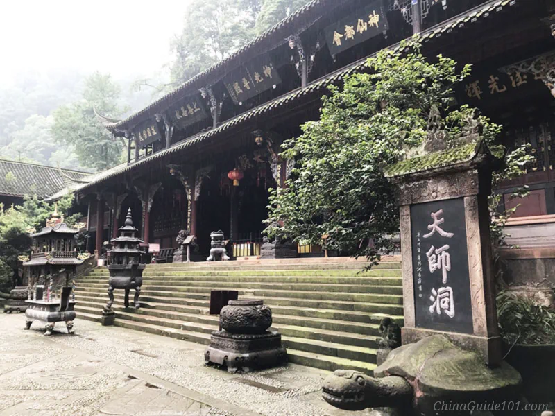 Tianshi Cave, an ancient Taoist temple building inside Mount Qingcheng, with stone tablet and incense burners