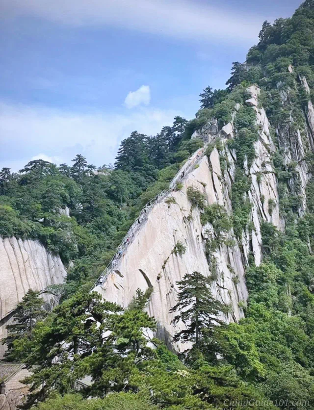 Dangerous narrow hiking trail of Black Dragon Ridge on Huashan Mountain, built along a sharp granite ridge