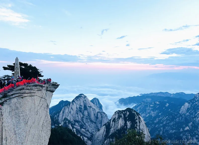 Sunrise viewing platform at Huashan East Peak, tourists waiting for sunrise above thick sea of clouds